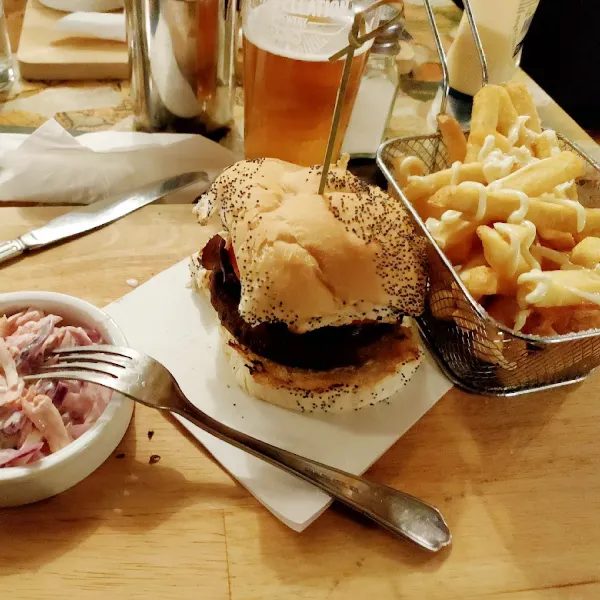 A burger and chips served in a basket at The Broad Oak
