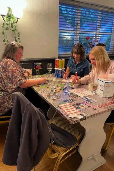 Guests at a table taking part in a quiz night at The Broad Oak